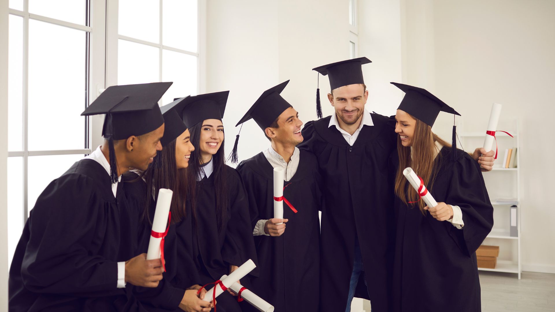 7 Key Traits Of A Diploma Provider That Can Help You Buy Replacement UK Diploma 2 graduates standing around in cap and gowns holding uk college diplomas