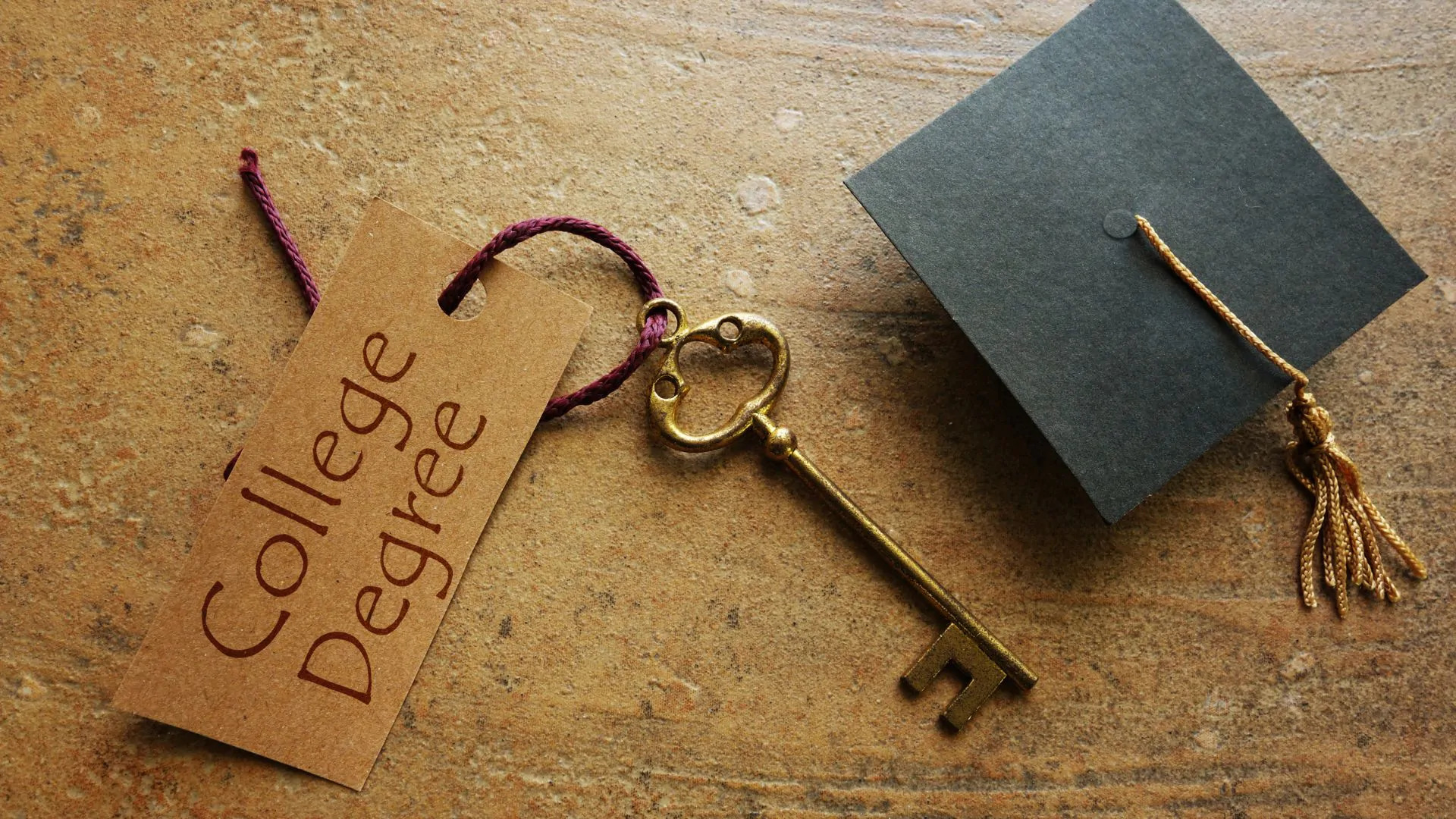 How to Obtain a College Diploma and Transcript Without Attending College? 2 old brass skeleton key next to a graduate cap representing the fact that college degrees are keys to education
