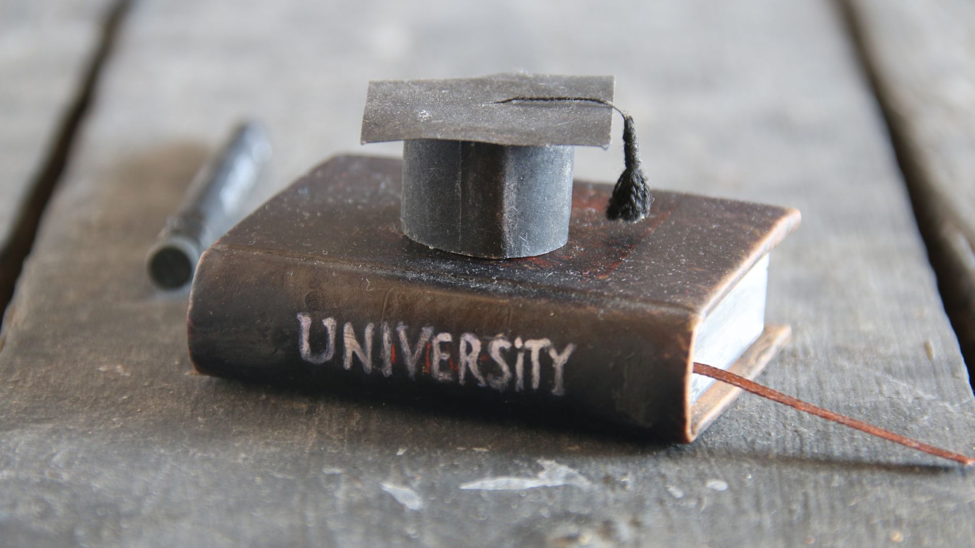 Key Points to Consider Before Buying A Canada Replacement Degree! 4 really cool miniature version of a university school book and graduation cap on a table